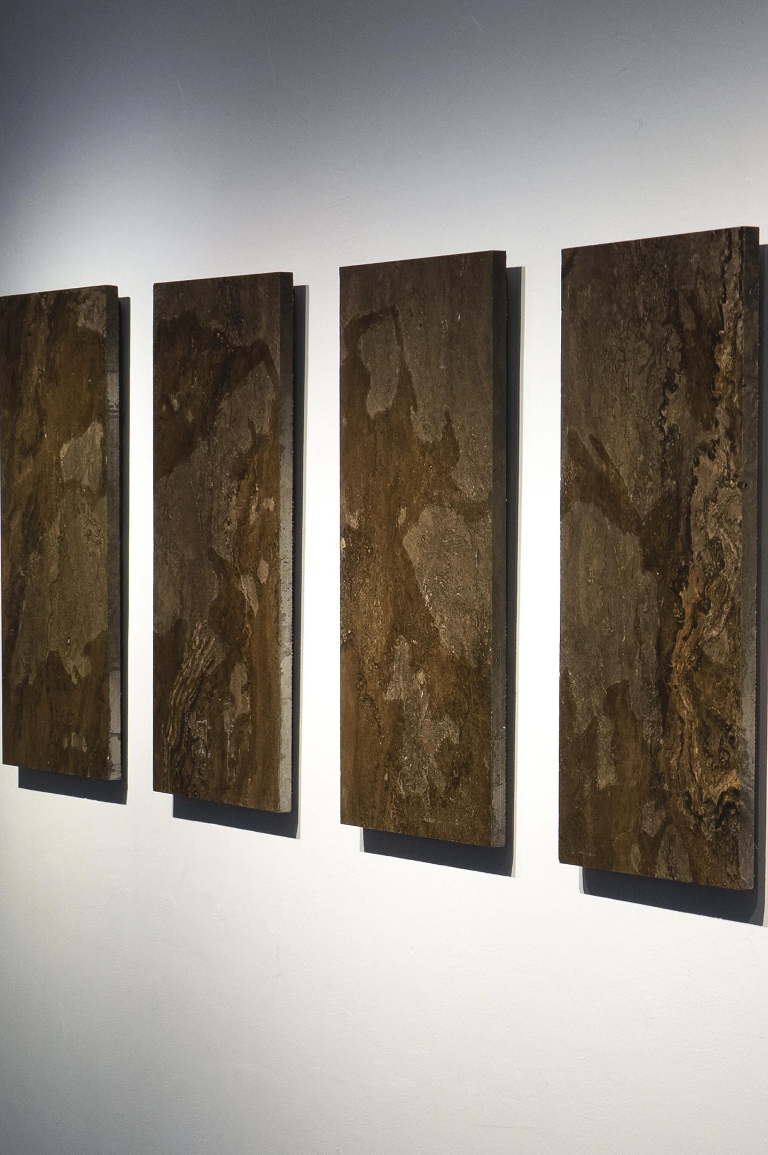 A close up installation view of 'All Downhill From Here' (2022 - 20247), A painting from Damian Boylan's Acid Paintings series, where acid is progressively painted on to a marble substrate, over a 25 year period, to progressively erode the underlying material.