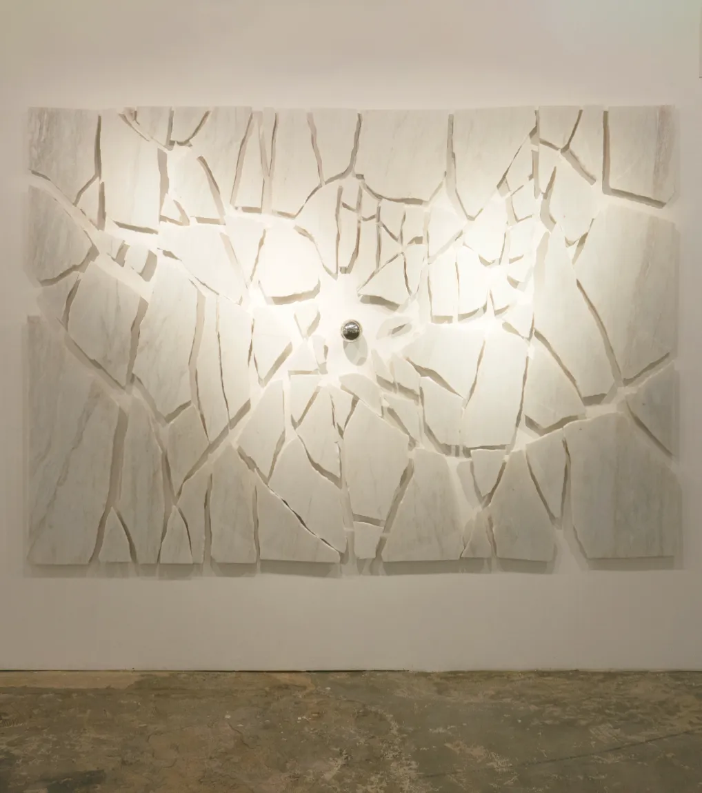An installation view of 'Libration' (2023), A painting from Damian Boylan's Acid Paintings series, where acid is progressively painted on to a marble substrate to progressively erode the underlying material.
