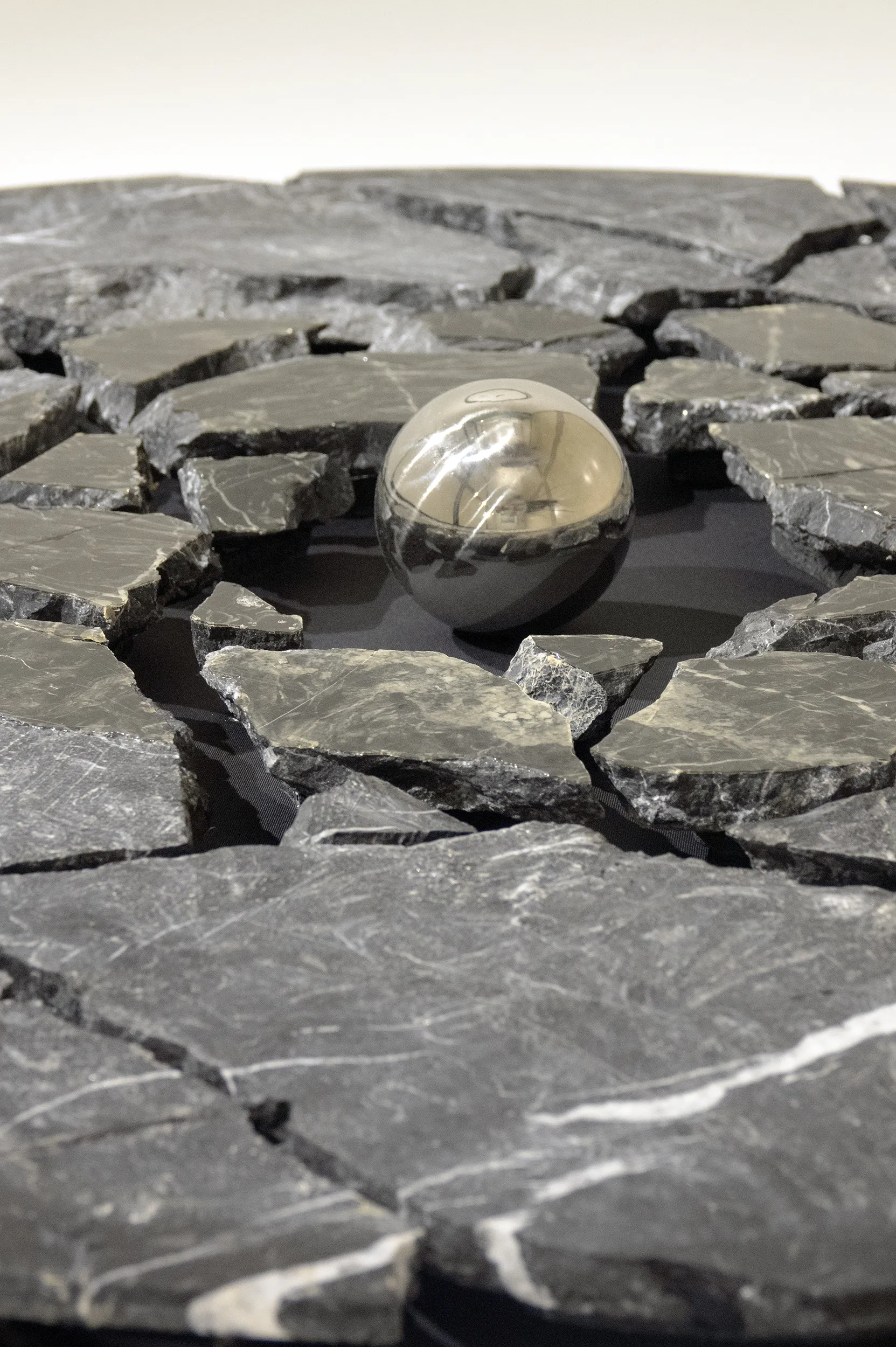 A detailed view of 'Monad: Second Chance' (2023), A painting from Damian Boylan's Acid Paintings series, where acid is progressively painted on to a marble substrate to progressively erode the underlying material.