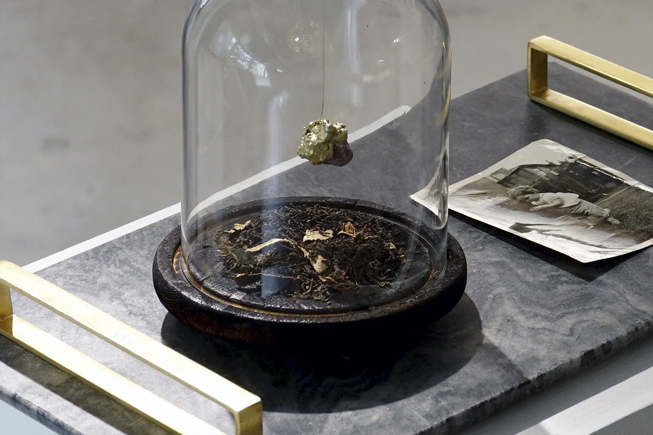 A close up view of ‘She Gave Me a Piece of Her Mind, Now I Gave You A Piece of Mine’ (2020) by Damian Boylan. A sculpture from his Elements series featuring molten Gold and other personal effects.