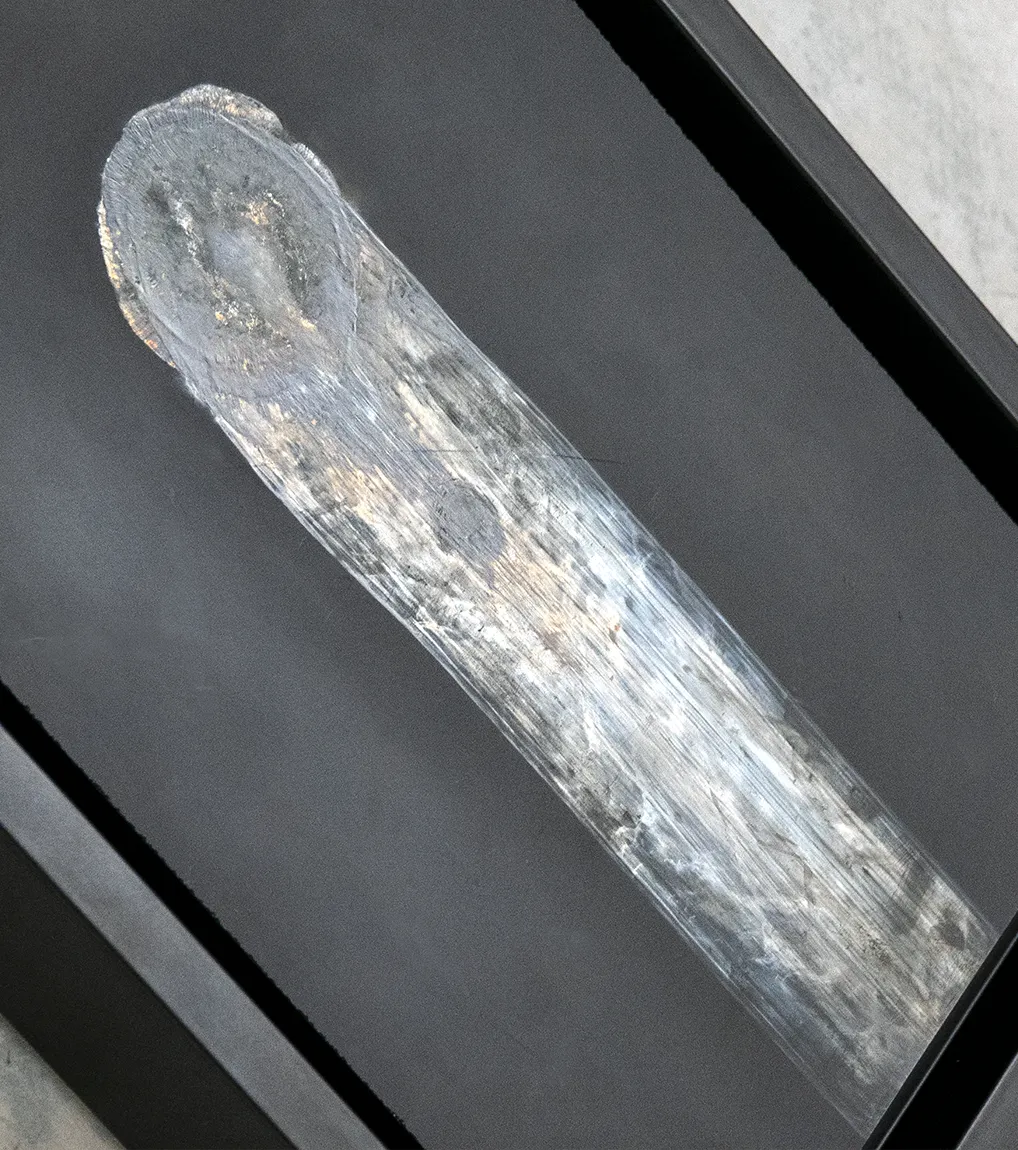 A close up view of Gossamer, 2020, a painting from artist Damian Boylan's Rarefactions series, showing molten brass leaving an iridescent residual mark on a poly(methyl methacrylate) canvas.